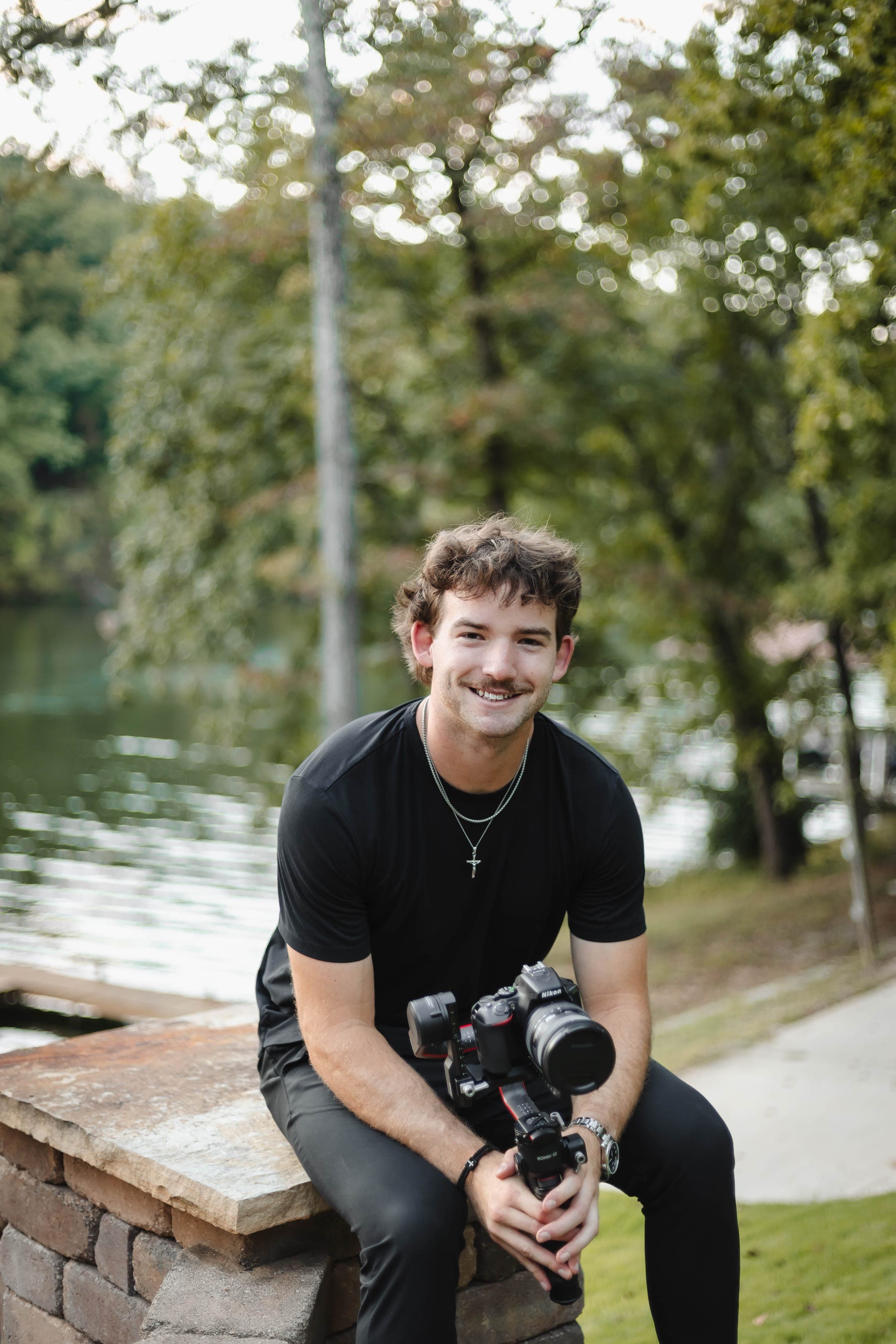 Rowe Gallagher with a camera by the water