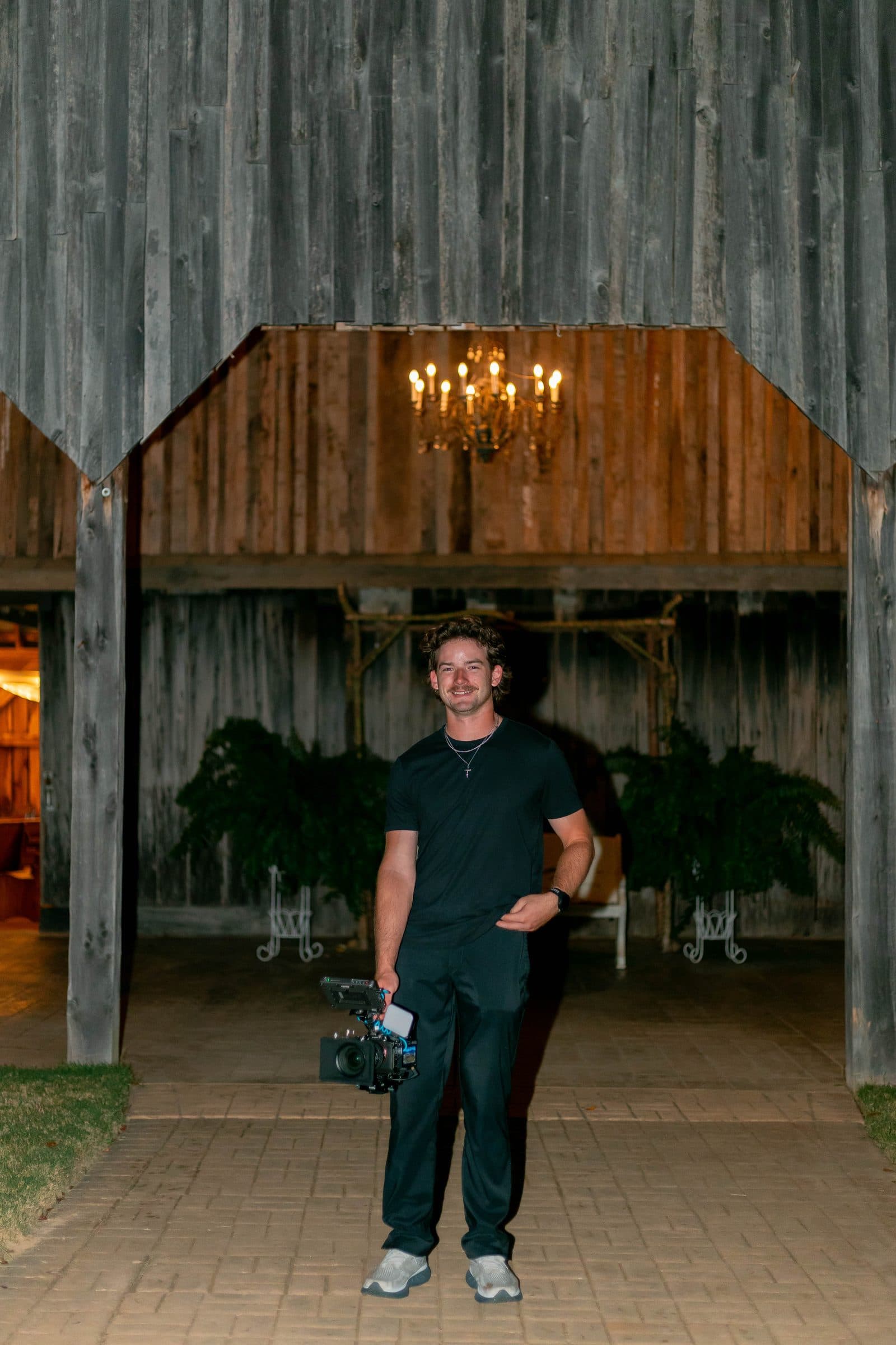 Rowe with his camera at a barn venue, ready for the ceremony